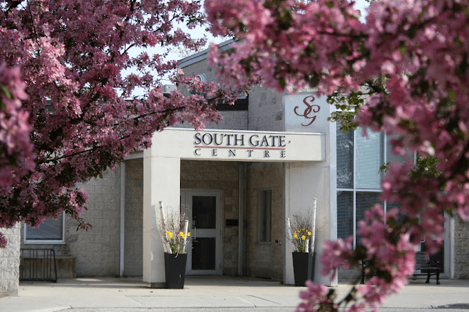 South Gate Centre framed by spring blossom, Woodstock